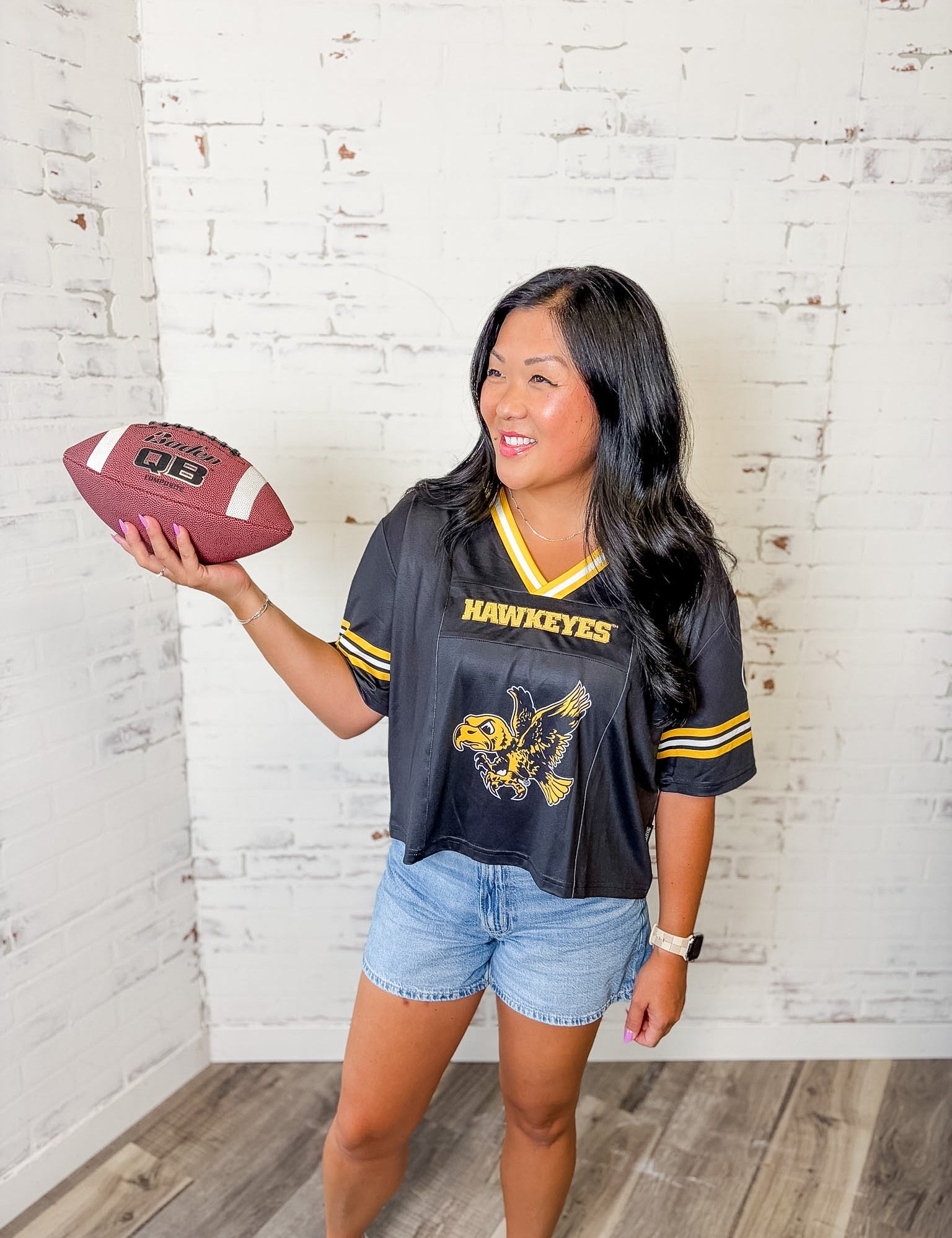 Iowa Hawkeyes women's black and gold football jersey with cropped fit