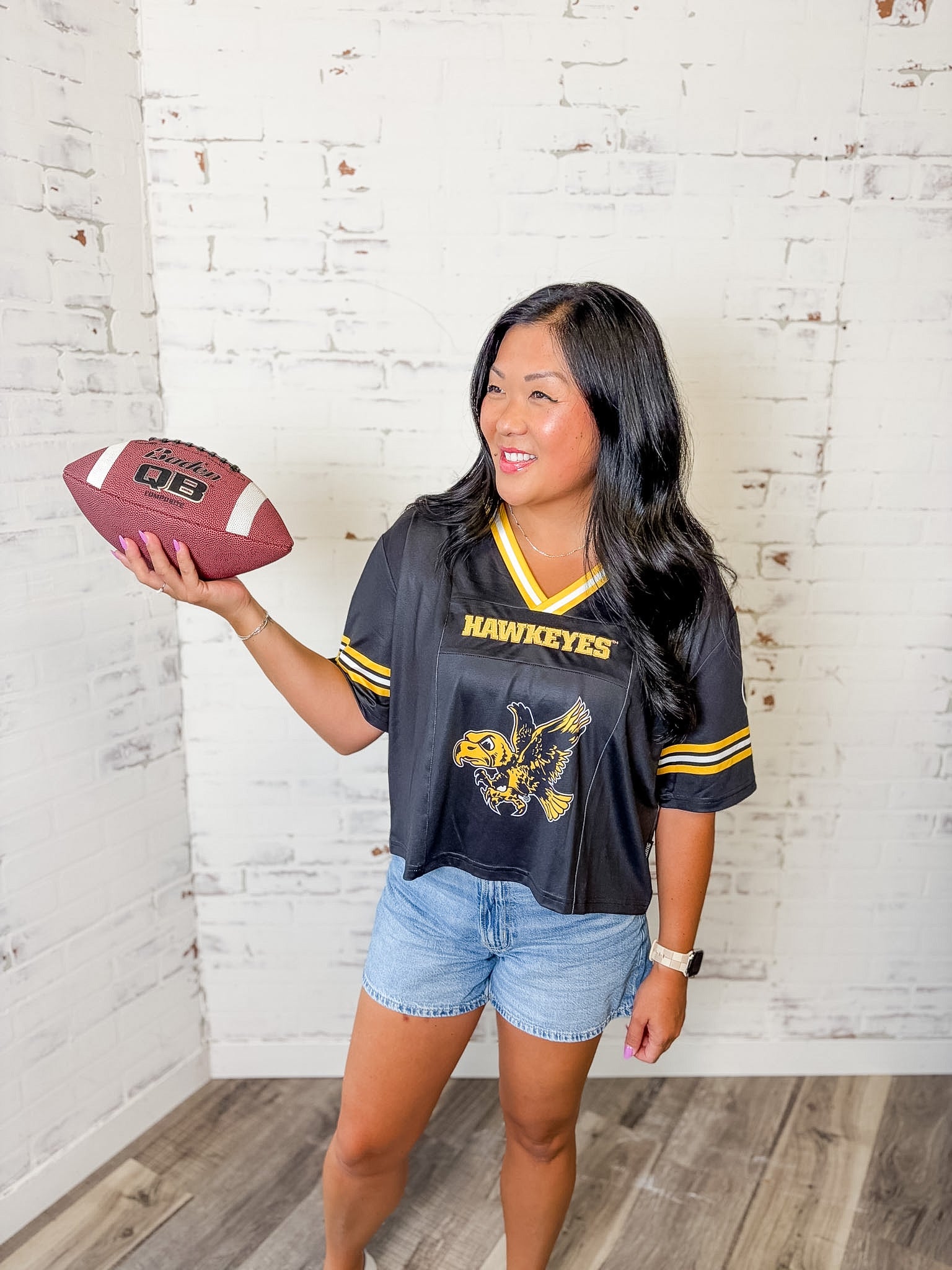 Iowa Hawkeyes women's black and gold football jersey with cropped fit
